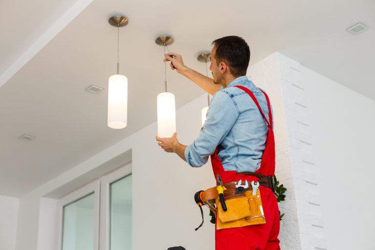 Electrician working on pendant light